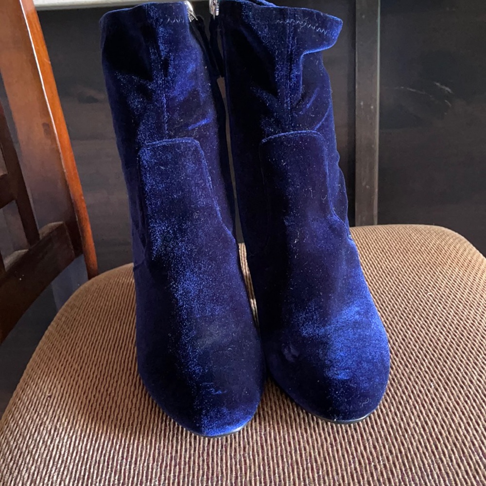 Zip up blue velvet heeled boots.
